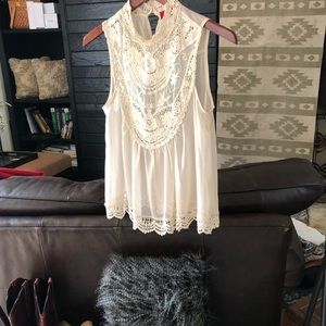 Cream sleeveless blouse with lace detail, sheer
